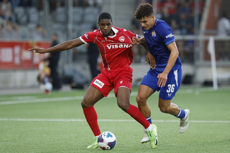 Thun's Brighton Labeau, left, and Zagreb's Sergi Dominguez in action during the UEFA Champions League second qualifying round match between Switzerland's FC Thun and Croatia's Dina ...