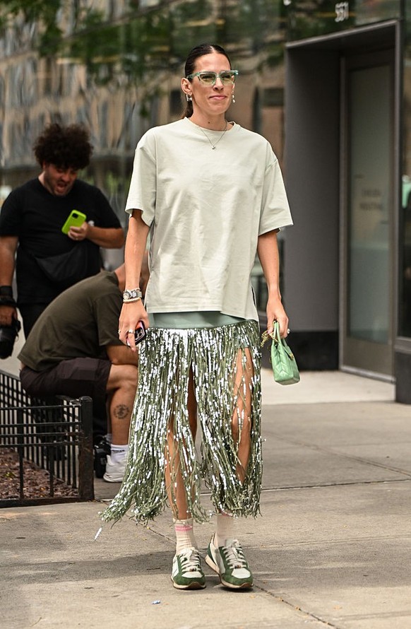 BERLIN, GERMANY - DECEMBER 10: Sonia Lyson is seen wearing black, oval-shaped Vehla sunglasses. Her outfit is cream-colored, consisting of a long, oversized faux fur coat that reaches her ankles. Unde ...
