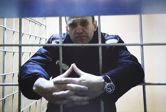 Russian opposition leader Alexei Navalny is seen in a video link from a prison, during a court session in Petushki, Vladimir region, about 120 kilometers (75 miles) east of Moscow, Russia, Tuesday, De ...