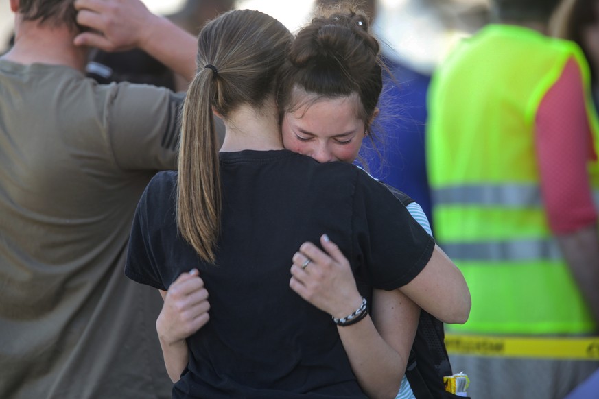 Students embrace after a school shooting at Rigby Middle School in Rigby, Idaho on Thursday, May 6, 2021. Authorities say a shooting at the eastern Idaho middle school has injured two students and a c ...