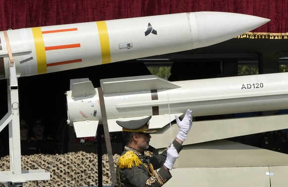 Missiles are carried on a truck as an Iranian army band leader conducts the music band during Army Day parade at a military base in northern Tehran, Iran, Wednesday, April 17, 2024. In the parade, Pre ...