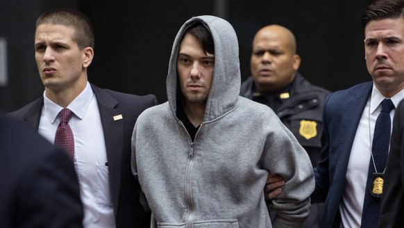 Martin Shkreli, the former hedge fund manager under fire for buying a pharmaceutical company and ratcheting up the price of a life-saving drug, is escorted by law enforcement agents in New York Thursd ...