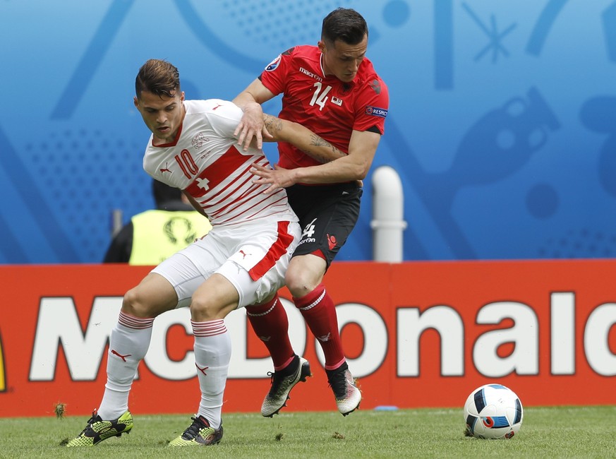 Switzerland's Granit Xhaka, left, and Albania's Taulant Xhaka vie for the ball during the Euro 2016 Group A soccer match between Albania and Switzerland, at the Bollaert stadium in Lens, Fra ...