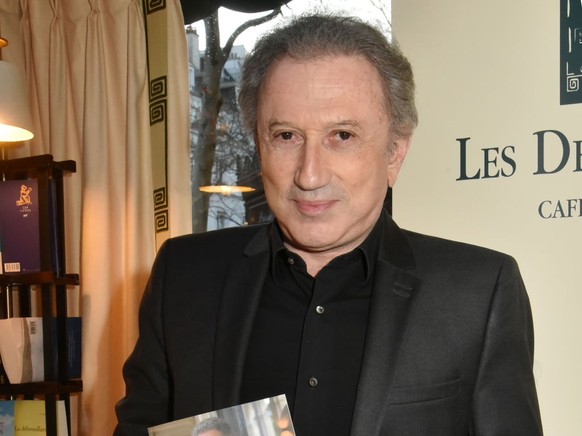 PARIS, FRANCE - MARCH 11: TV presenter Michel Drucker attends &quot;Il Faut Du Temps Pour Rester Jeune&quot; Michel Drucker Book Signing au Deux Magots on March 11, Paris, France. (Photo by Foc Kan/Wi ...