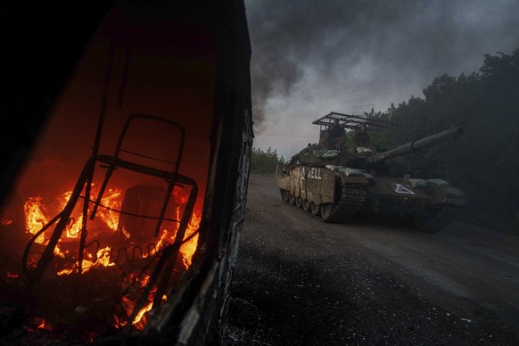 FILE - A Ukrainian tank passes by a burning car near the Russian-Ukrainian border in the Sumy region of Ukraine, Aug. 14, 2024. (AP Photo/Evgeniy Maloletka, File)
Russia Ukraine Kursk