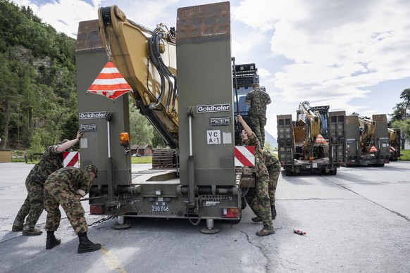 Soldiers of the Military Disaster Relief, the Katastrophenhilfe Bereitschaftsbatallion (Kata Hi Ber Bat) of the Swiss Army, prepare heavy machinery to aid the site of the catastrophic mud slide that c ...