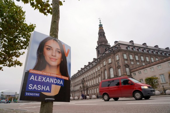 A photo taken on October 22, 2022 shows a Venstre election poster of Alexandra Sasha attached to a tree in front of Christiansborg Palace, the Danish parliament building, in Copenhagen, Denmark, ahead ...