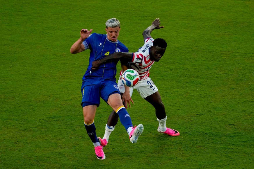 United States' Folarin Balogun (20) fouls Bosnia's Tarik Muharemovic (4) during the World Cup round of 32 soccer match between the United States and Bosnia in Santa Clara, Calif., near San F ...