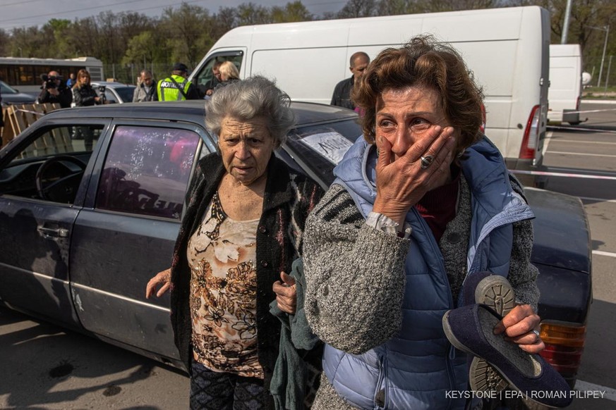 epa09922167 Natalia (R) and her mother Dina (L) react after arriving from Mariupol to an evacuation point in Zaporizhzhia, Ukraine, 02 May 2022. Thousands of people who still remain trapped in Mariupo ...