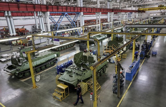 epa10740199 A handout photo made available by the Russian Defence ministry press-service shows a general view inside a military armored vehicle factory during a visit by Russian Defence Minister Gener ...