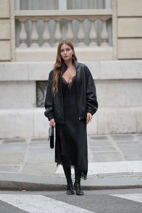 BERLIN, GERMANY - DECEMBER 10: Sonia Lyson is seen wearing black, oval-shaped Vehla sunglasses. Her outfit is cream-colored, consisting of a long, oversized faux fur coat that reaches her ankles. Unde ...