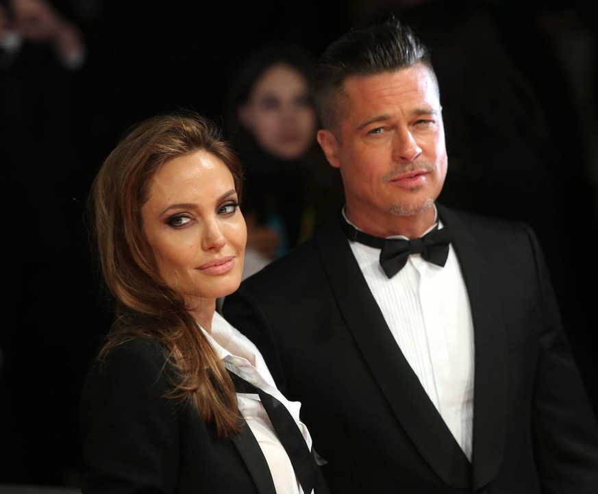 Actors Angelina Jolie and Brad PItt pose for photographers on the red carpet at the EE British Academy Film Awards held at the Royal Opera House on Sunday Feb. 16, 2014, in London. (Photo by Joel Ryan ...