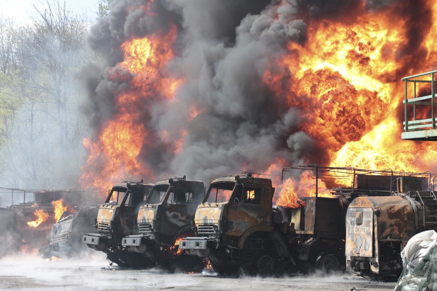 Vehicles on fire at the oil depot after missiles struck the facility in an area controlled by Russian-backed separatist forces in Makiivka, 15 km (94 miles) east of Donetsk, eastern Ukraine, Wednesday ...