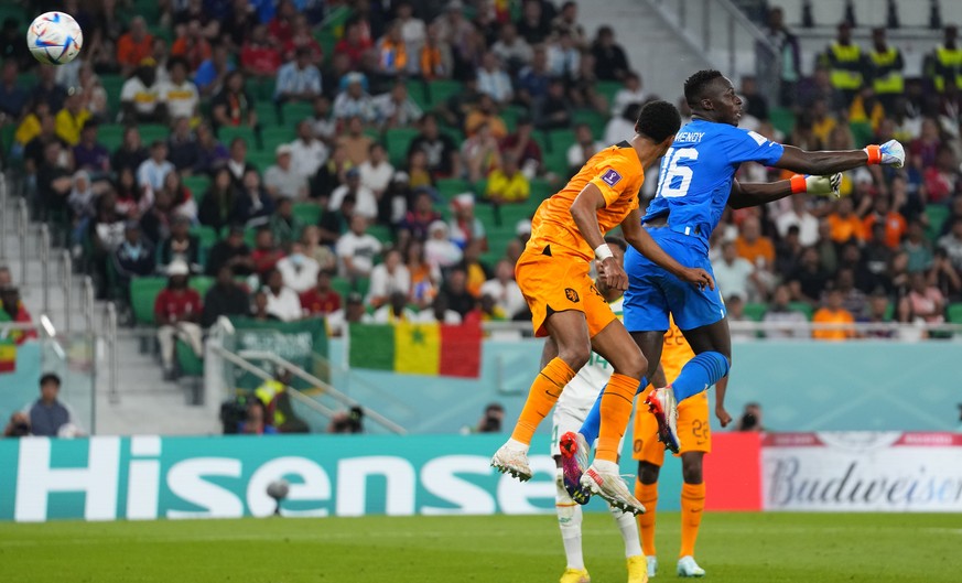 Cody Gakpo of the Netherlands, left, scores the opening goal during the World Cup, group A soccer match between Senegal and Netherlands at the Al Thumama Stadium in Doha, Qatar, Monday, Nov. 21, 2022. ...