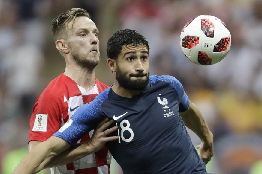 Croatia&#039;s Ivan Rakitic challenges for the ball France&#039;s Nabil Fekir during the final match between France and Croatia at the 2018 soccer World Cup in the Luzhniki Stadium in Moscow, Russia,  ...