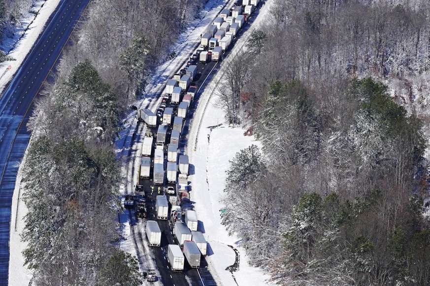 Drivers wait for the traffic to be cleared as cars and trucks are stranded on sections of Interstate 95 Tuesday Jan. 4, 2022, in Carmel Church, Va. Close to 48 miles of the Interstate was closed due t ...