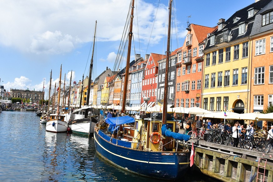 Copenhagen, Denmark. August 2019 : Scenic summer view of Nyhavn pier. Colorful building facades with boats and yachts in the Old Town .