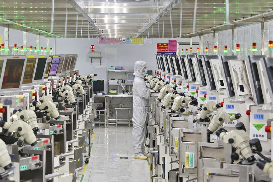 A man works at a manufacturer of Integrated Chip encapsulation in Nantong in eastern China&#039;s Jiangsu province on Friday, Sept. 16, 2022. Growth in Chinese factory activity was weak in September,  ...