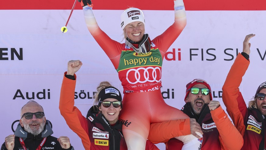 epa10944850 Winner Lara Gut-Behrami of Switzerland celebrates with her team on the podium for the Women's Giant Slalom race of the FIS Alpine Skiing World Cup season opener on the Rettenbach glac ...