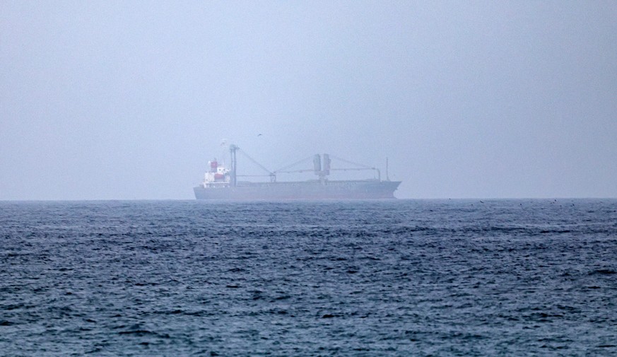 epa13125318 Cargo vessels are seen at one end of the Strait of Hormuz near the coast of Dibba Al Fujairah, United Arab Emirates, 21 July 2026. EPA/STRINGER