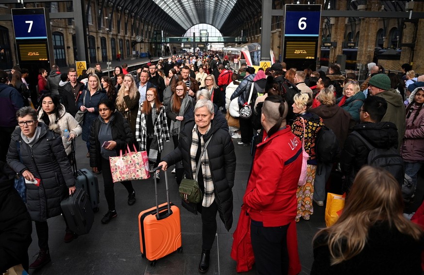 Commuters at a train station in London, Britain, 05 December 2022. The RMT (Rail, Maritime and Transport ) union has rejected an offer from train operators aimed at preventing strikes over Christmas,  ...