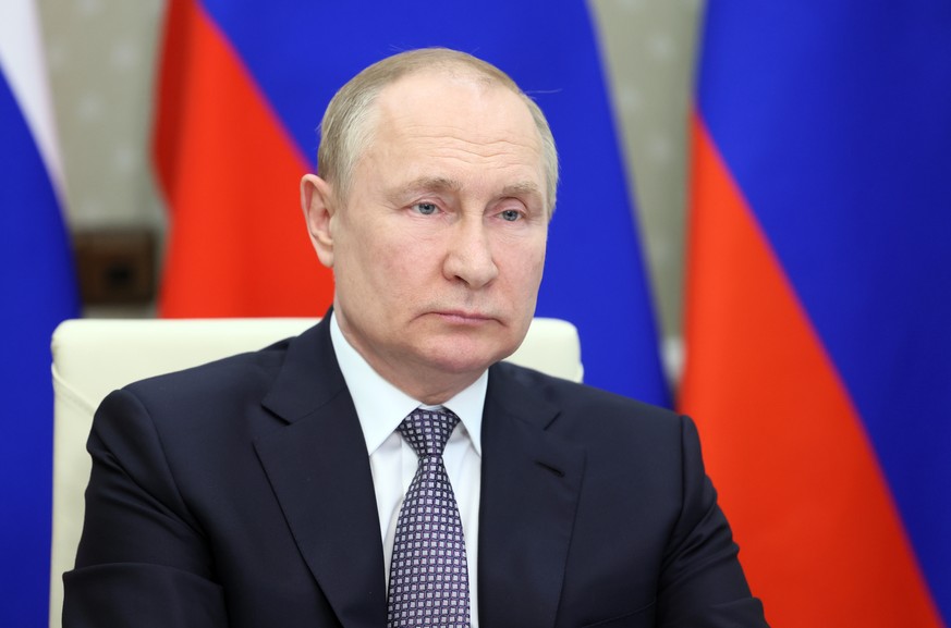 epa10031903 Russian President Vladimir Putin attends a BRICS Plus session involving the leaders of several invited states during the 14th BRICS summit in virtual format, via a video call at the Novo-O ...