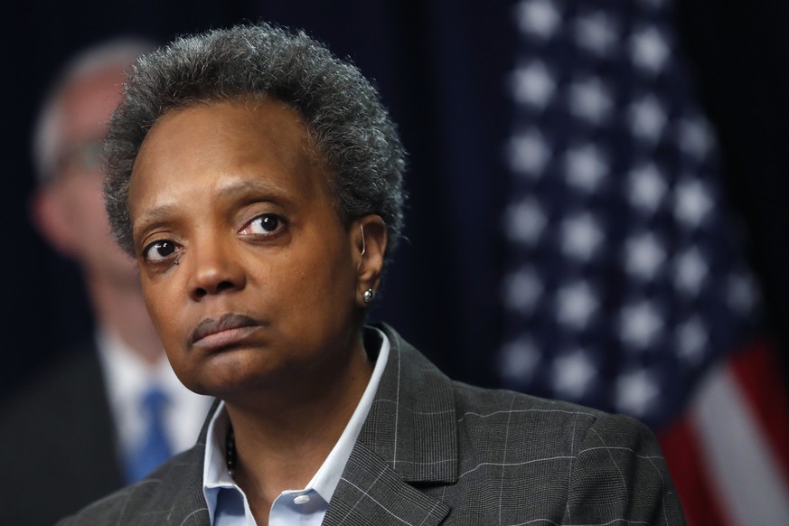 FILE - In this Friday, March 20, 2020, file photo, Chicago Mayor Lori Lightfoot listens to a question after Illinois Gov. J.B. Pritzker announced a shelter-in-place order to combat the spread of the C ...