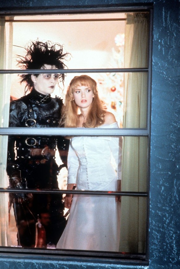 Johnny Depp and Winona Ryder looking out window in a scene from the film 'Edward Scissorhands', 1990. (Photo by 20th Century-Fox/Getty Images)