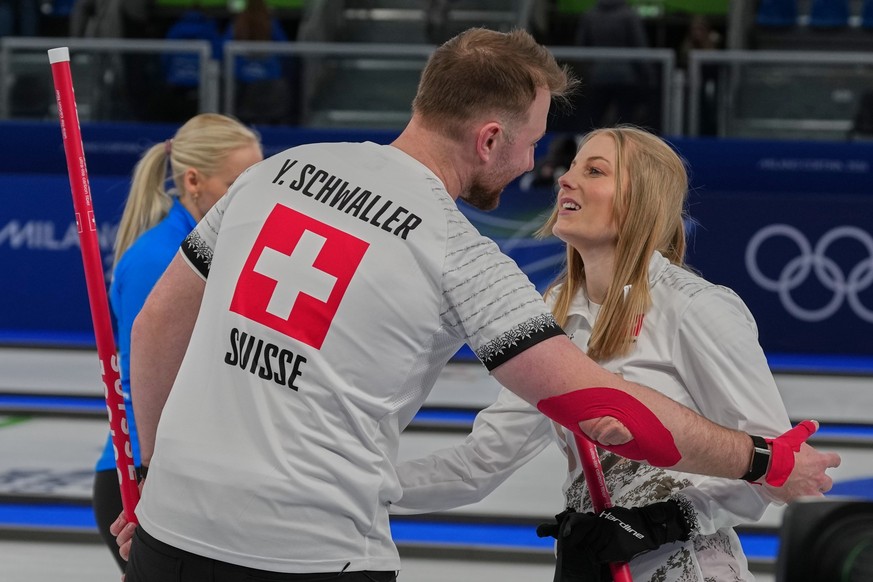 Switzerland's Yannick Schwaller, left, celebrates with Briar Schwaller-Huerlimann after they won the mixed doubles round robin phase of the curling competition against Estonia at the 2026 Winter  ...