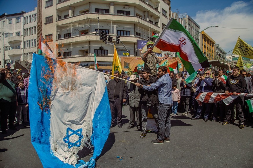 Funeral of IRGC members killed in Syria Iranian demonstrators burn a representation of the Israeli flag as one of them waves Iranian and Palestinian flags during an annual rally to mark Quds Day, or J ...