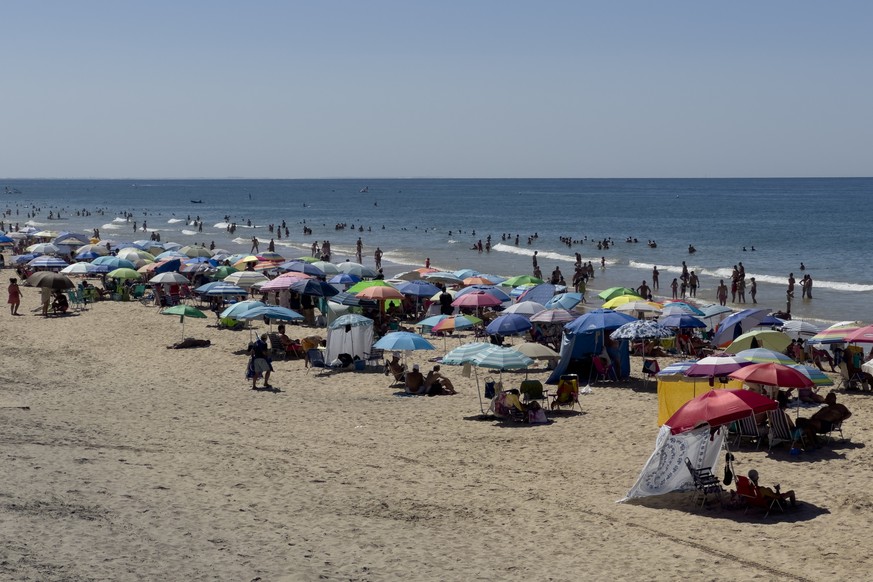 epa11554092 Hundreds of people pack Matalascanas Beach in Huelva, southern Spain, 18 August 2024. Areas of the Spanish regions of Andalusia, Castile-La Mancha, Extremadura, Murcia, and the Canary Isla ...
