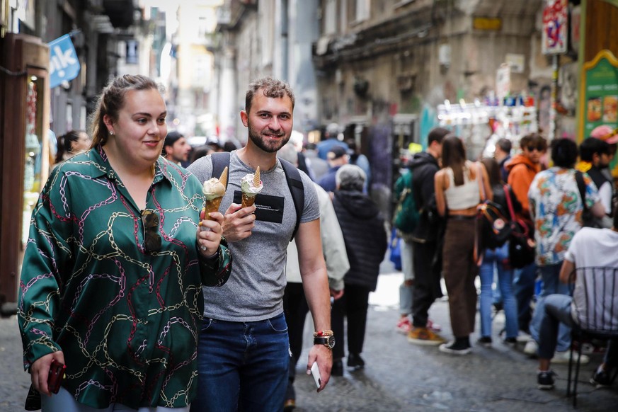 epa09920414 People in the historic center of Naples, southern Italy, 01 May 2022, on the day when new COVID-19 rules come into force. Most of Italy's remaining COVID-19 restrictions will be dropp ...