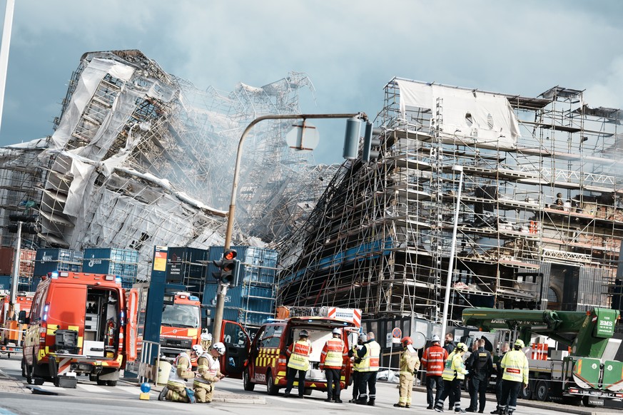The outer wall of the Stock Exchange has collapsed towards Boersgade, Copenhagen, Thursday, April 18, 2024. A fire raged through one of Copenhagen?s oldest buildings on Tuesday, causing the collapse o ...