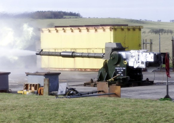 A depleted uranium shell is fired from a Challenger 2 tank gun barrel mounted on a 120mm gun stand, at the Kirkcudbright Training Area in Scotland, Tuesday Feb. 20 2001. Campaigners called for a morat ...