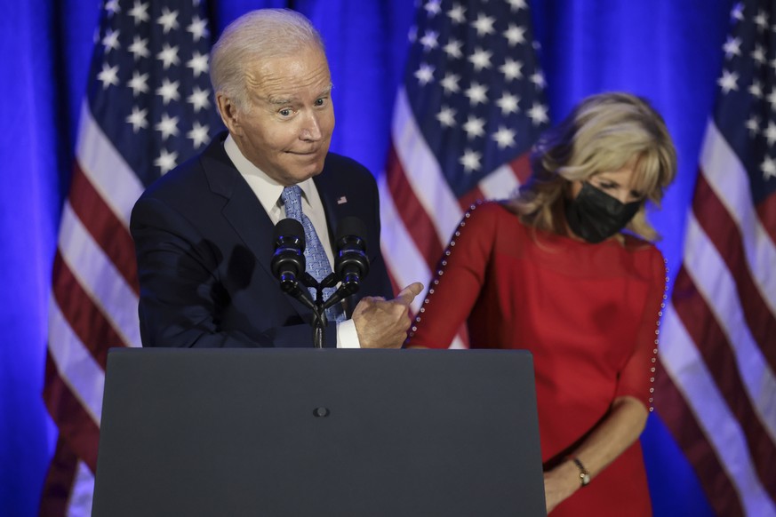 epa09642348 US President Joe Biden joined by First Lady Jill Biden, speaks during a holiday celebration for the Democratic National Committee at the Hotel Washington, in Washington, DC, USA, 14 Decemb ...