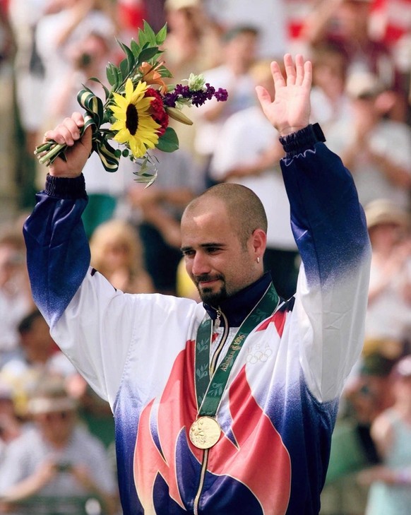 America&#039;s Andre Agassi receives his gold medal after defeating Spain&#039;s Sergi Bruguera at the Stone Mountain Tennis Center Saturday August 3, 1996. Agassi won 6-2, 6-3, 6-1 at the Centennial  ...