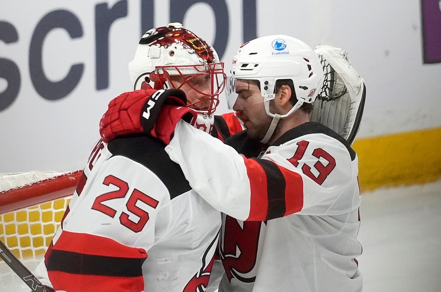New Jersey Devils goaltender Jacob Markstrom (25) celebrates as time runs out with centre Nico Hischier (13) as the Devils defeat the Ottawa Senators in an NHL hockey game, in Ottawa, Ontario, Tuesday ...