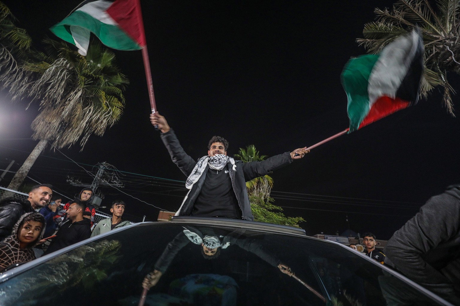 epa11826825 Palestinians react to news of a ceasefire agreement with Israel, in Deir al Balah, central Gaza Strip, 15 January 2025. According to US and Hamas officials, Israel and Hamas agreed on a ho ...