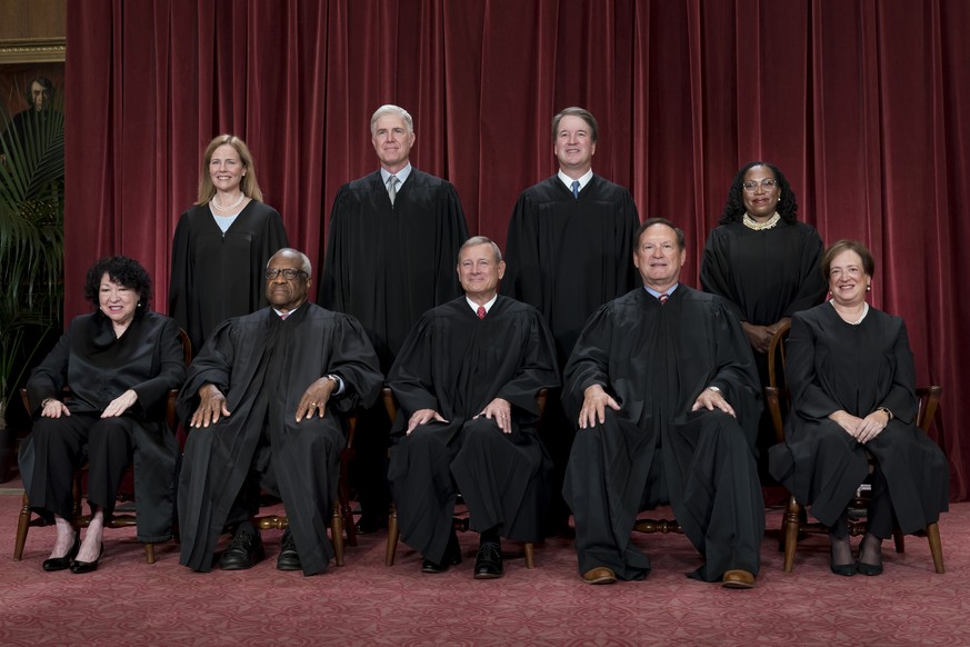 Members of the Supreme Court sit for a new group portrait following the addition of Associate Justice Ketanji Brown Jackson, at the Supreme Court building in Washington, Friday, Oct. 7, 2022. Bottom r ...