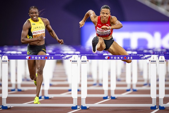 Ditaji Kambundji of Switzerland, center, competes to win gold next to Danielle Williams of Jamaica, left, in the women's 100 meters hurdles final on day three of the World Athletics Championships ...