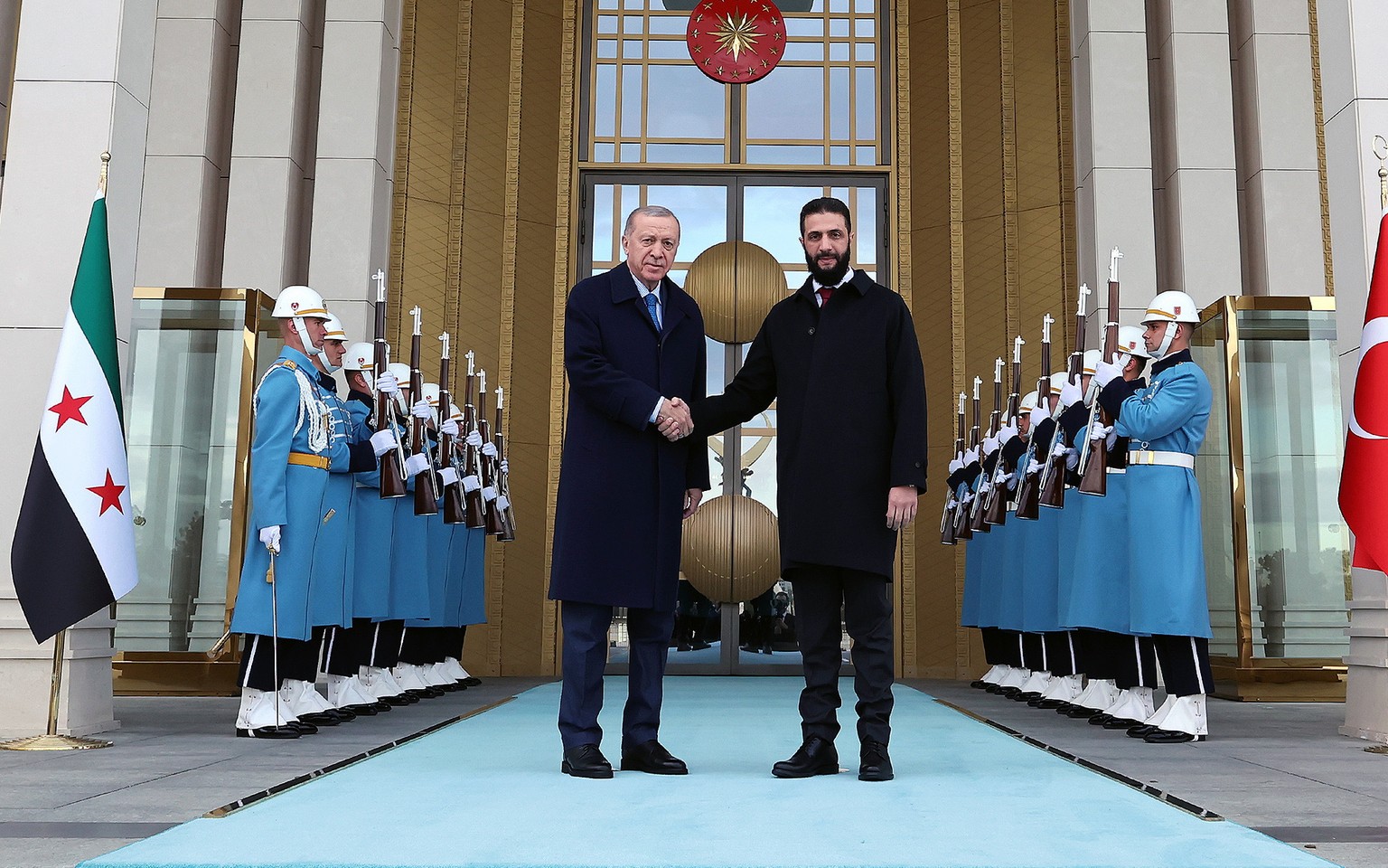 epa11874766 A handout photo made available by the Turkish Presidency Press Office shows Turkish President Recep Tayyip Erdogan (L) shaking hands with Syrian interim President Ahmed al-Sharaa (R) durin ...
