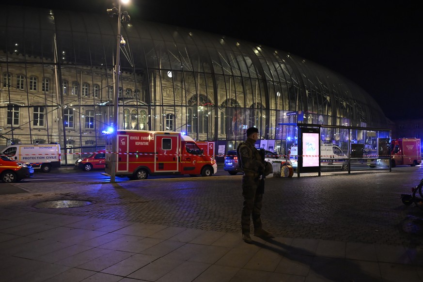 A soldier guards the train station after two trams collided, injuring dozens of people, though none critically, firefighters said, Saturday, Jan. 11, 2025 in Strasbourg, eastern France. (AP Photo/Pasc ...