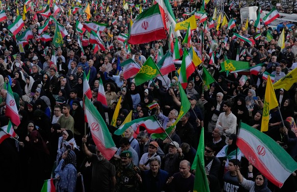 People wave Iranian flags during a state-organised rally in Tehran, Iran, Wednesday, April 29, 2026, celebrating the birthday of Imam Reza, the 8th Shiite Muslims' Imam, and showing their support ...
