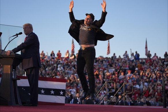 Elon Musk jumps on the stage as Republican presidential nominee former President Donald Trump speaks at a campaign rally at the Butler Farm Show, Saturday, Oct. 5, 2024, in Butler, Pa. (AP Photo/Evan  ...
