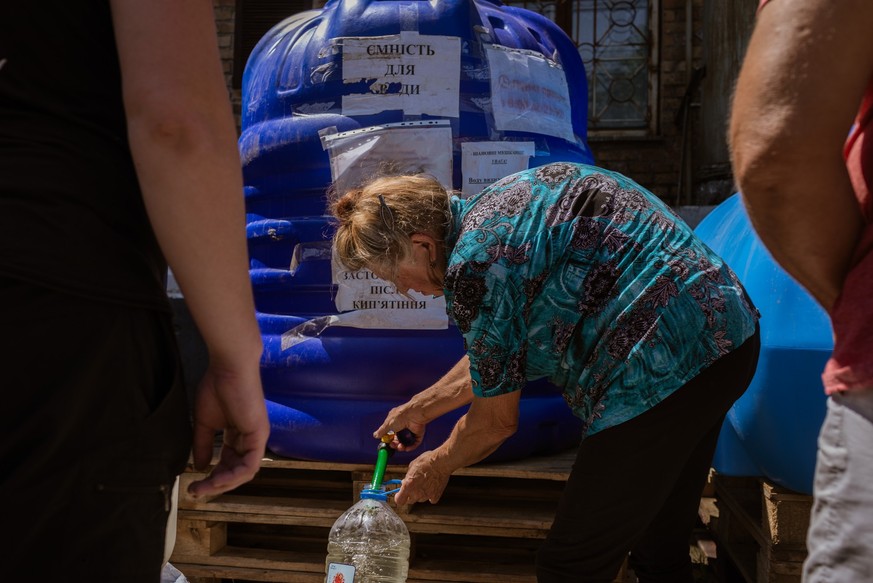 NIKOPOL, UKRAINE - JULY 3: Locals get water from a distribution point as water shortage continues for several weeks in Nikopol, Ukraine on July 3, 2023. Nikopol under a nuclear threat as the city is w ...