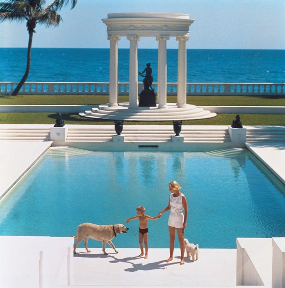 American writer C.Z. Guest (Mrs F.C. Winston Guest, 1920 - 2003) and her son Alexander Michael Douglas Dudley Guest in front of their Grecian temple pool on the ocean-front estate, Villa Artemis, Palm ...