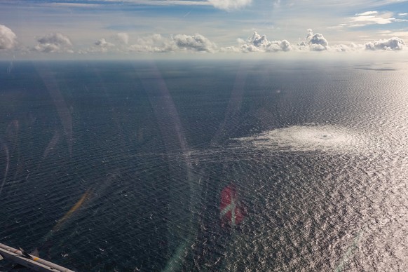 epa10209594 A handout photo taken from a Danish F-16 jet on 27 September 2022 and made available by the Danish Defence Command shows a gas leak of the Nord Stream 2 pipeline off Bornholm, Denmark, Bal ...