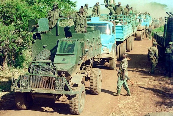 KAM01 - 20020414 - SOUTH SUDAN, SUDAN : Ugandan soldiers drive military trucks in south Sudan region 14 April 2002 after operations in the zone where the Ugandan army claims to besiege Lord&#039;s Res ...