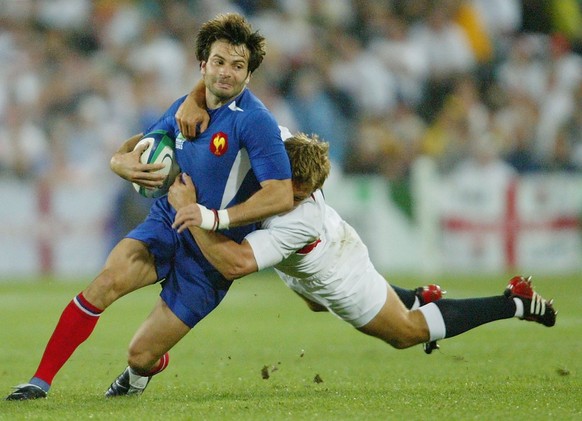 SYDNEY, AUSTRALIA - NOVEMBER 16: Christophe Dominici of France is tackled by Jonny Wilkinson during the Rugby World Cup Semi-Final match between England and France at Telstra Stadium November 16, 2003 ...
