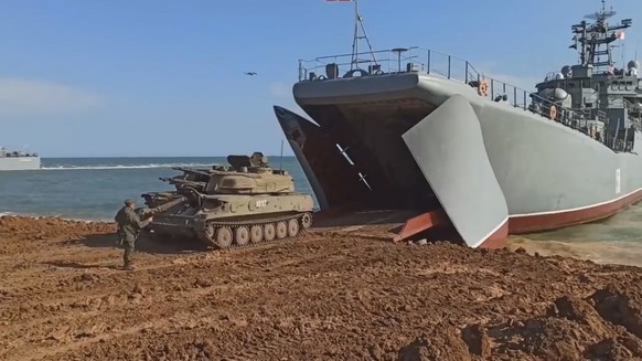 epa09154975 A still image taken from a handout video footage made available 23 April 2021 by the press service of the Russian Defence Ministry shows Russian armored military vehicles rolling into a Ru ...